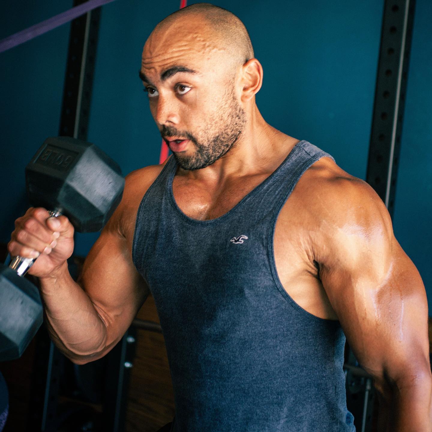 Member focused on a dumbbell curl at Lift Society