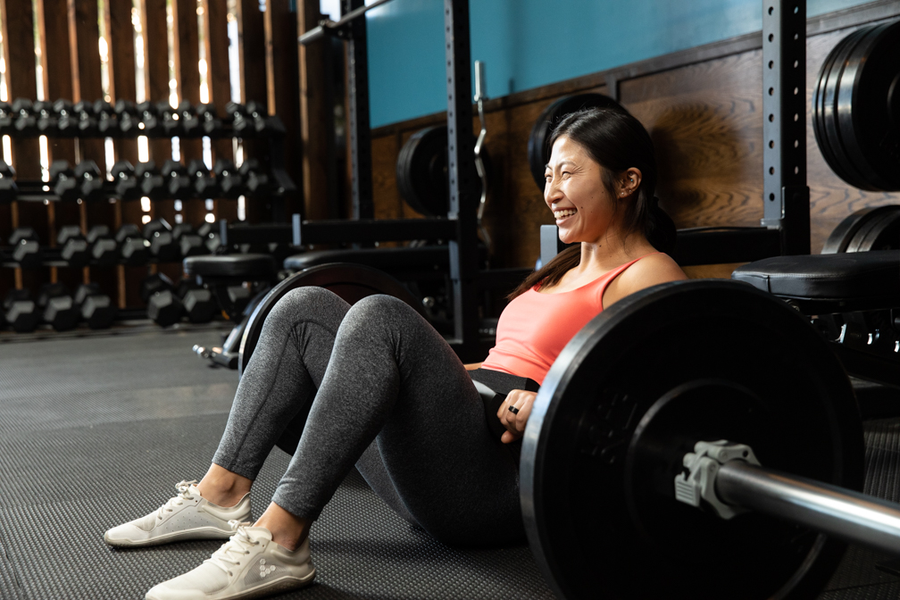 Member smiling after a barbell hip thrust at Lift Society